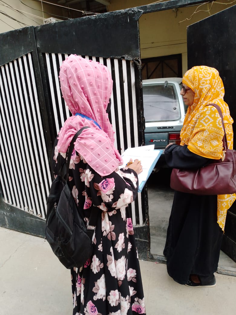 Field survey team conducting household interviews - Click Karachi