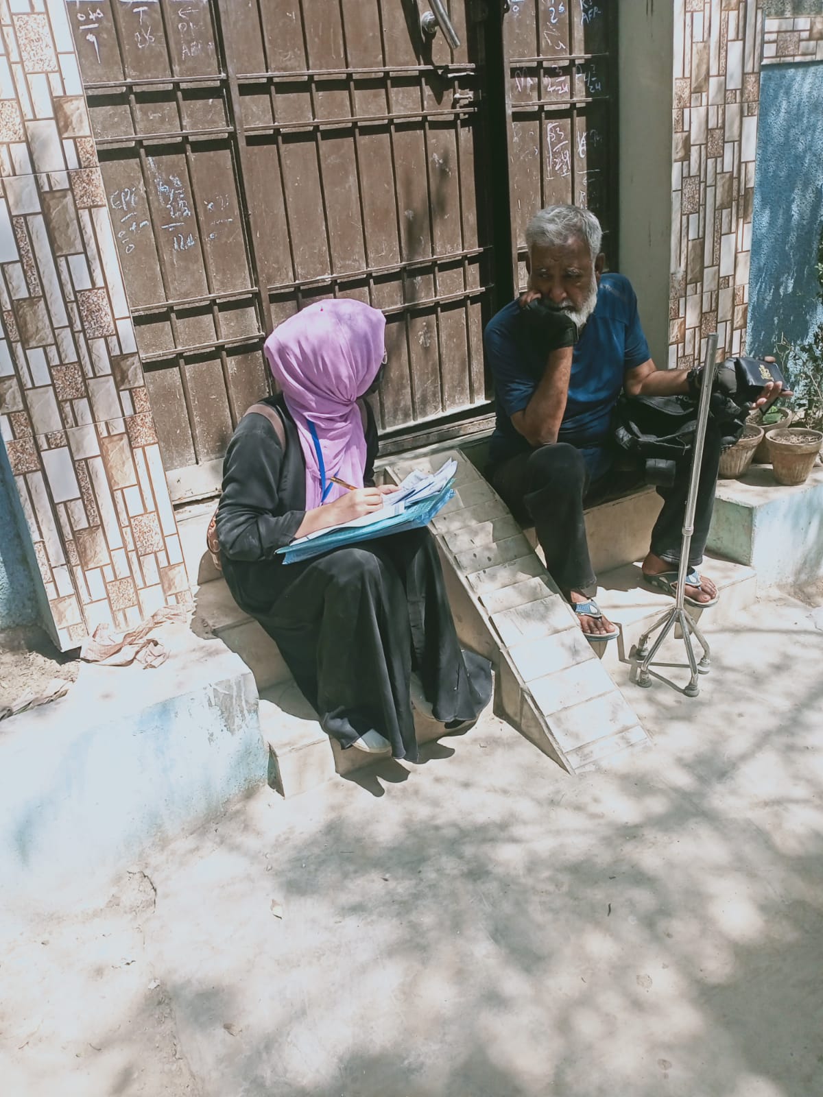 Field interviewer with community resident - Click Karachi survey