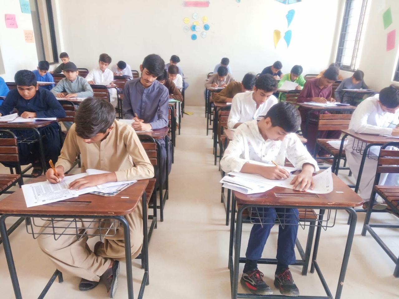 Students sitting examination - quality education programme